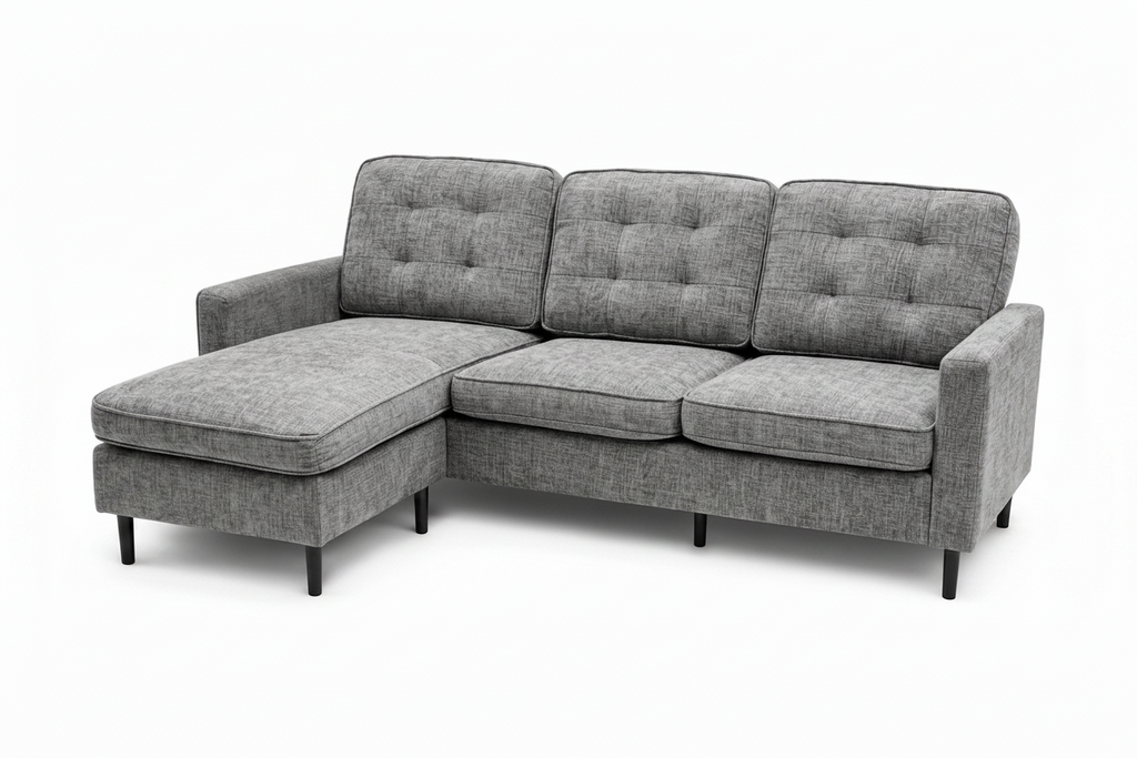 A gray upholstered sectional sofa with a left-facing chaise lounge, featuring tufted back cushions, three seat cushions, and slim black legs, shown against a plain white background.