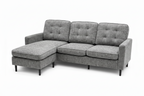 A gray upholstered sectional sofa with a left-facing chaise lounge, featuring tufted back cushions, three seat cushions, and slim black legs, shown against a plain white background.