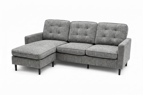 A gray upholstered sectional sofa with a left-facing chaise lounge, featuring tufted back cushions, three seat cushions, and slim black legs, shown against a plain white background.