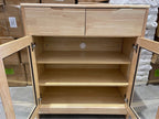 Wooden cabinet with open doors in a storage area