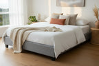Sand upholstered bed frame with wooden slats on a white background