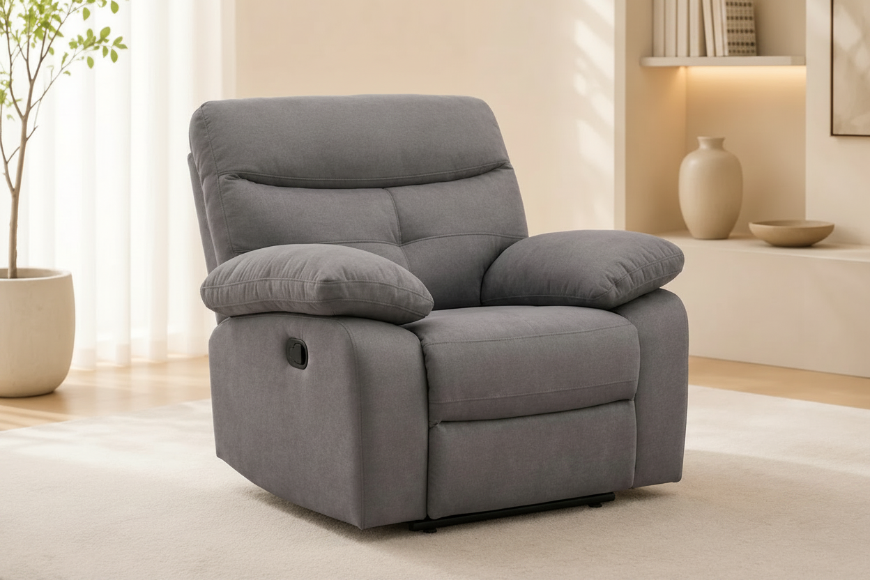 Gray recliner chair in a living room setting with a plant and shelves in the background.