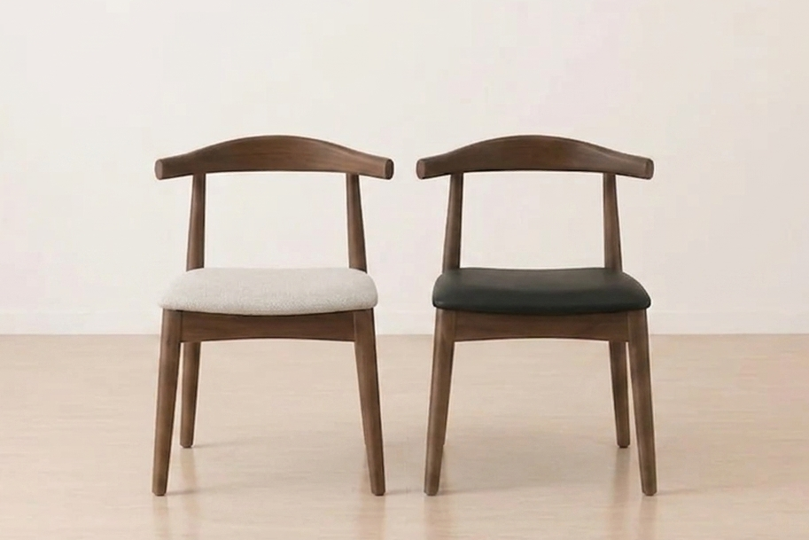 Two wooden chairs with cushioned seats on a light wooden floor.