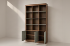 A tall wooden bookcase with a warm medium-brown finish, featuring twelve open shelves and two lower cabinet doors in a muted sage green color, shown open on a light neutral studio background.