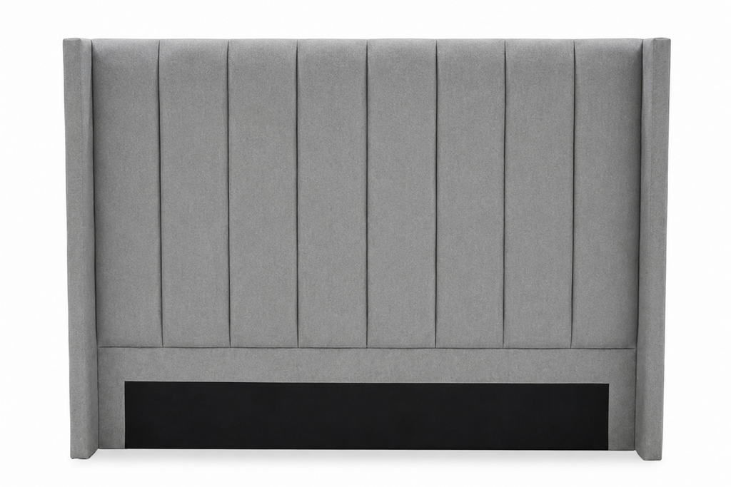 A gray upholstered headboard with vertical channel tufting and a black panel at the base, shown against a plain white background.