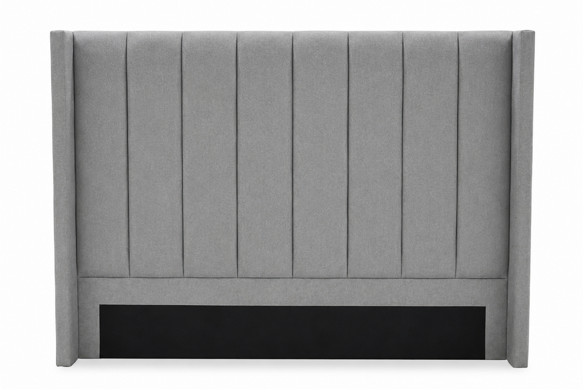 A gray upholstered headboard with vertical channel tufting and a black panel at the base, shown against a plain white background.