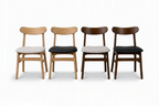 Four wooden chairs with different seat colors on a white background