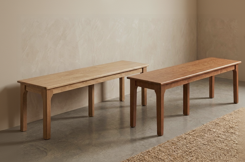 Two wooden benches against a beige wall with a textured floor.