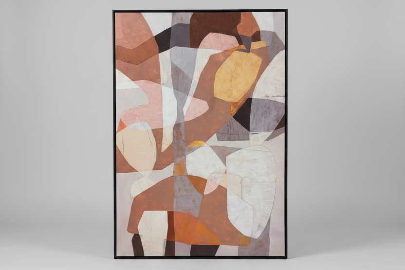 A framed abstract geometric wall art print with overlapping shapes in terracotta, beige, brown, gray, and white, shown against a light gray studio background.