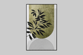 A framed minimalist art print featuring a textured olive green and white background, black leaf silhouettes, and a black semi-circular line pattern at the bottom, displayed on a light gray wall.
