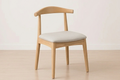 The wooden chairs with cushioned seats on a light background